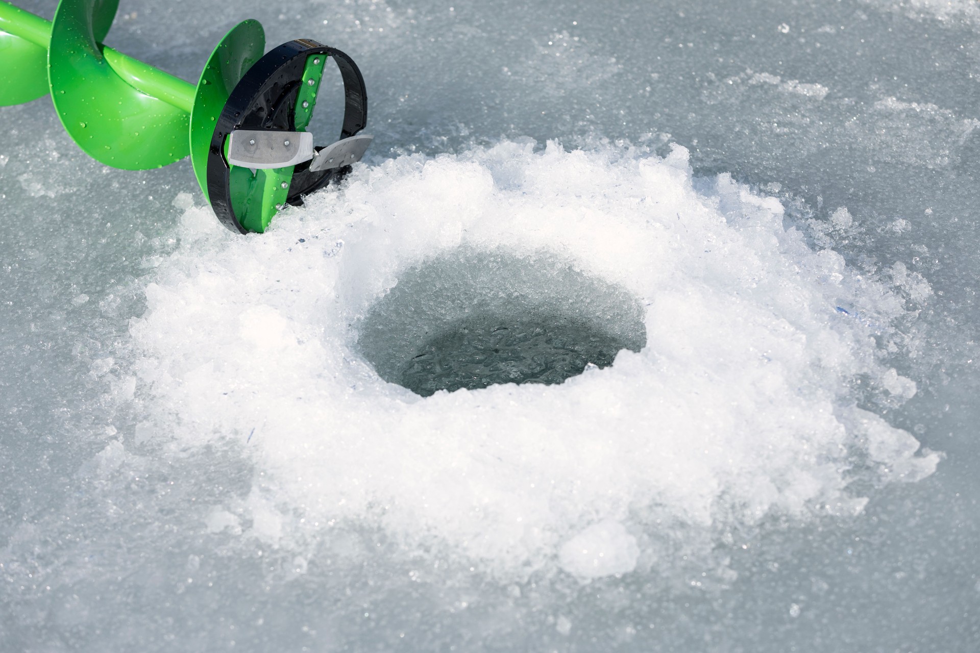 Ice Fishing Hole with Ice Auger