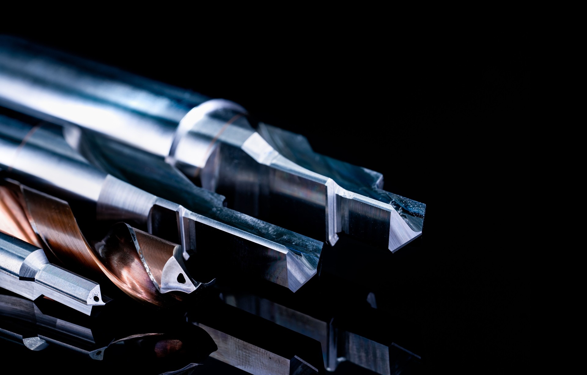 Special tools isolated on black background. Made to order special tools. Coated step drill and reamer detail. HSS cemented carbide. Carbide cutting tool for industrial applications. Engineering tools.